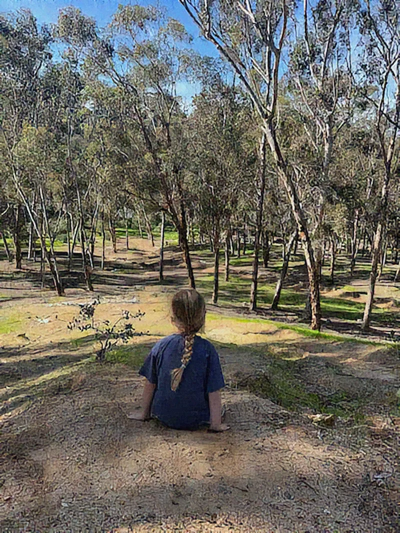 Denoised: grainy phone photo of a child in a park